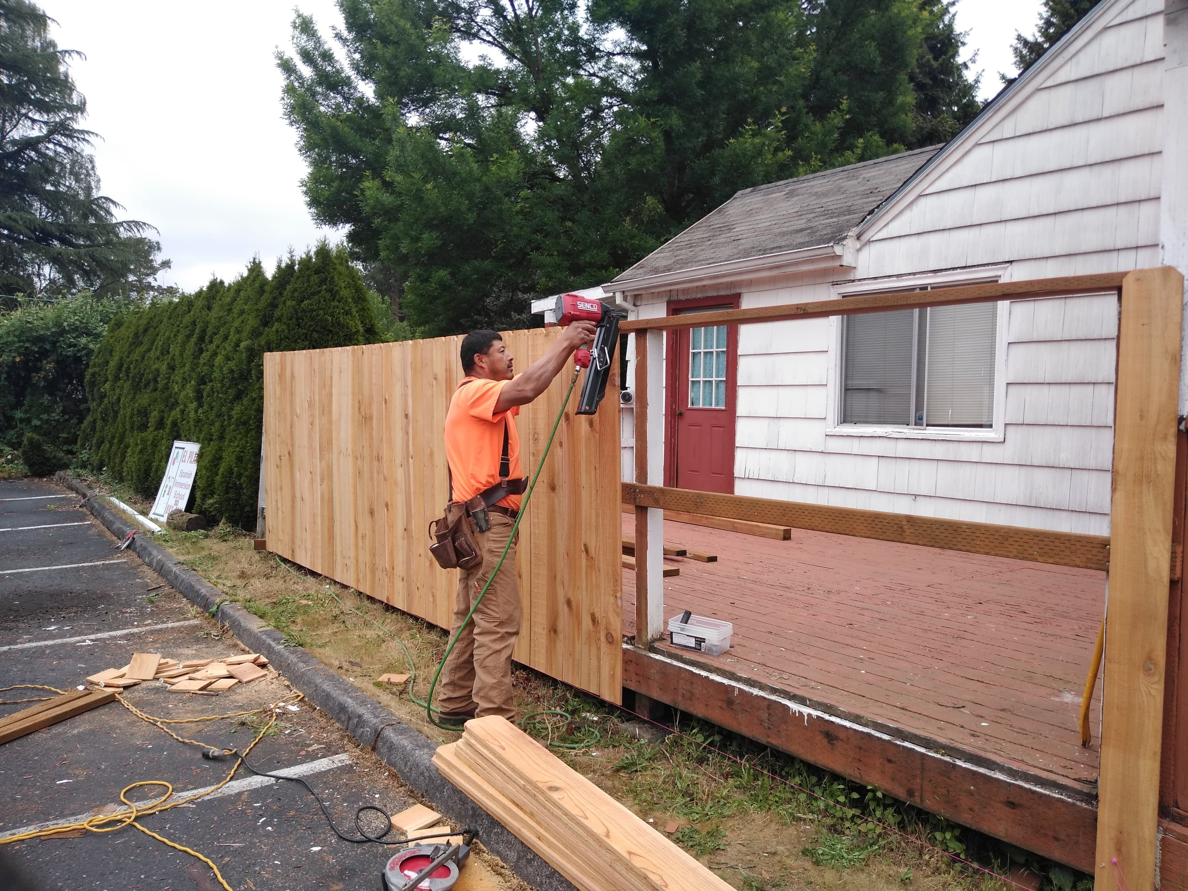 Handyman putting up a fence